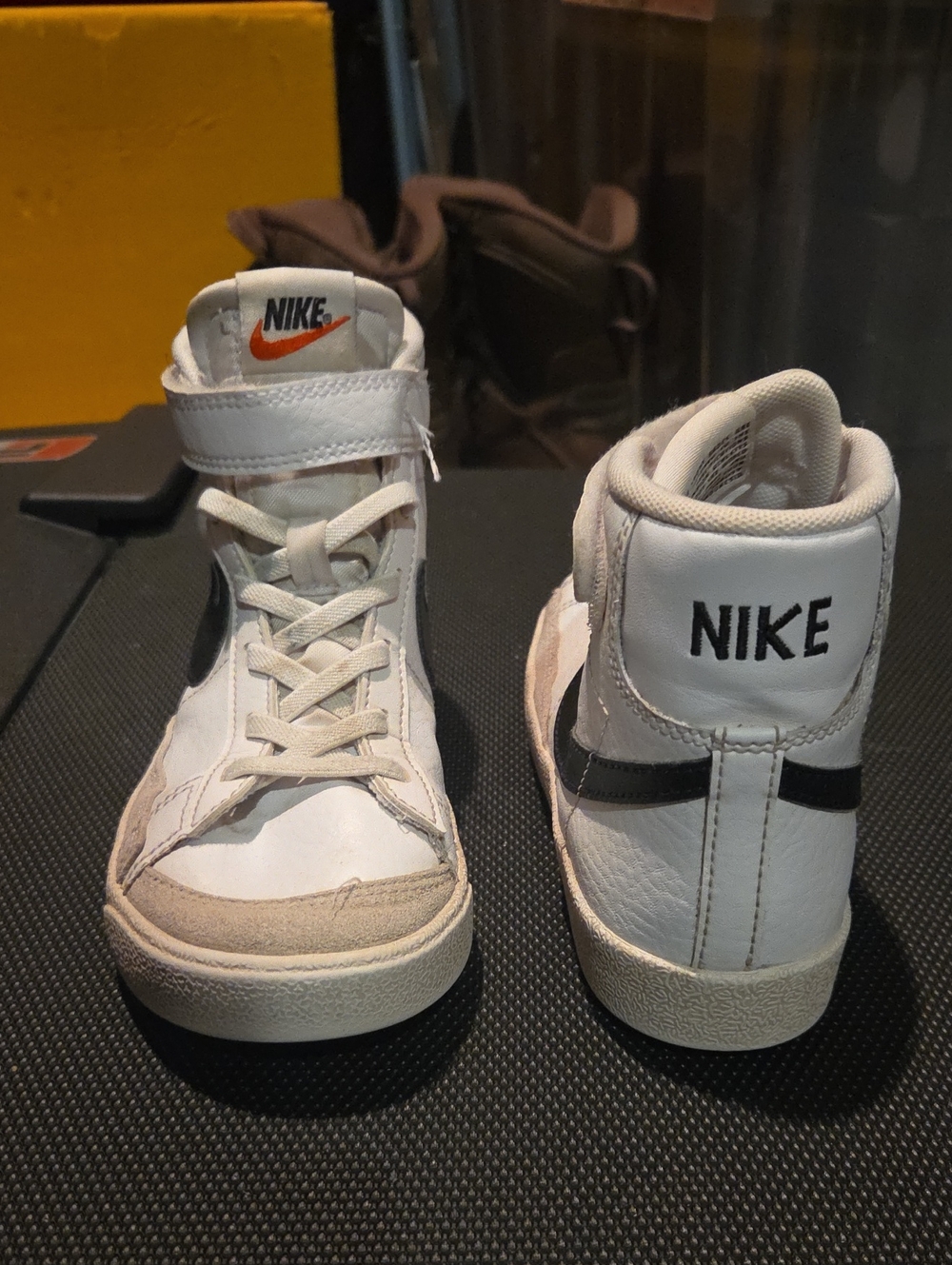 Nike White High-Top Kids Sneakers with Black Swoosh and Orange Logo